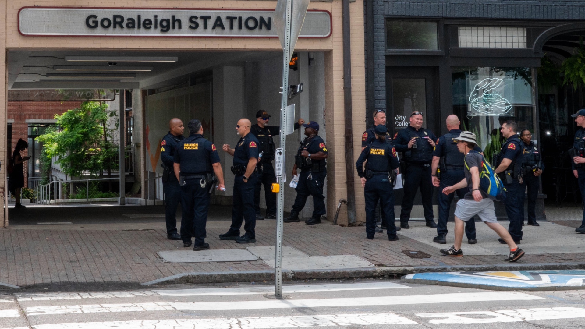 Police officers standing outside bus station