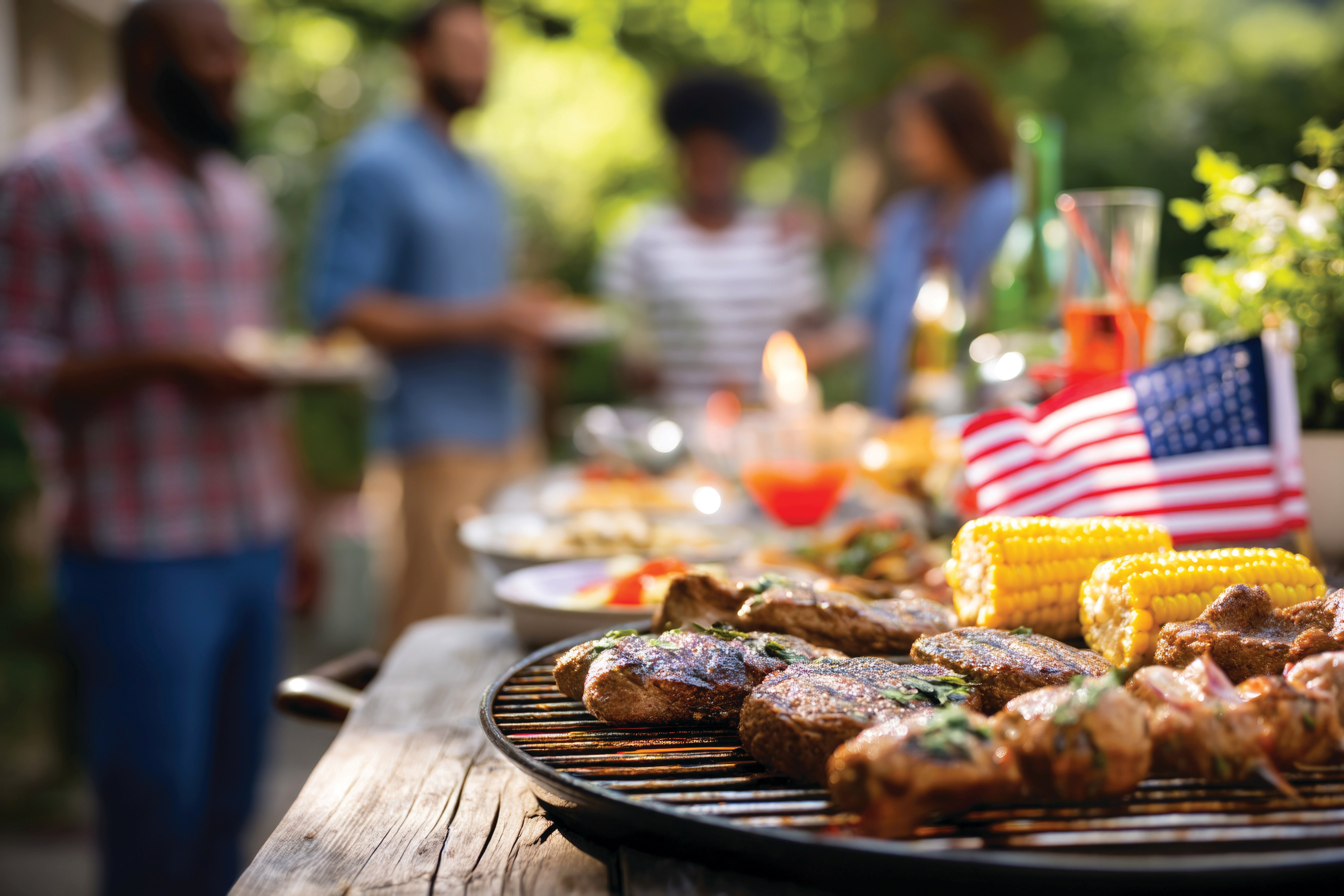 People standing behind grill for celebration 