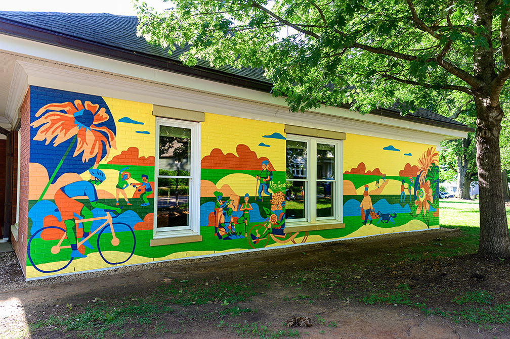 A brightly colored mural depicting pedestrians and cyclists 