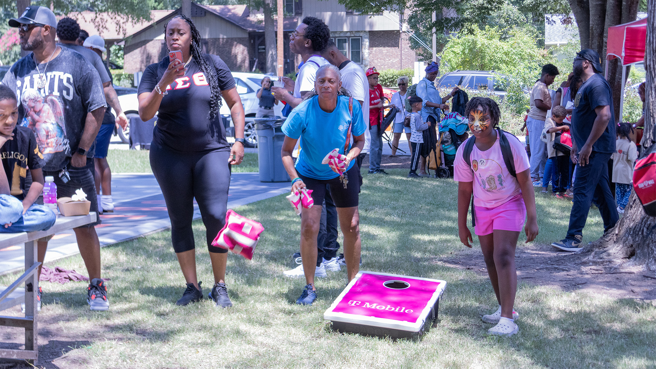 a family playing cornhole and enjoying the outdoors