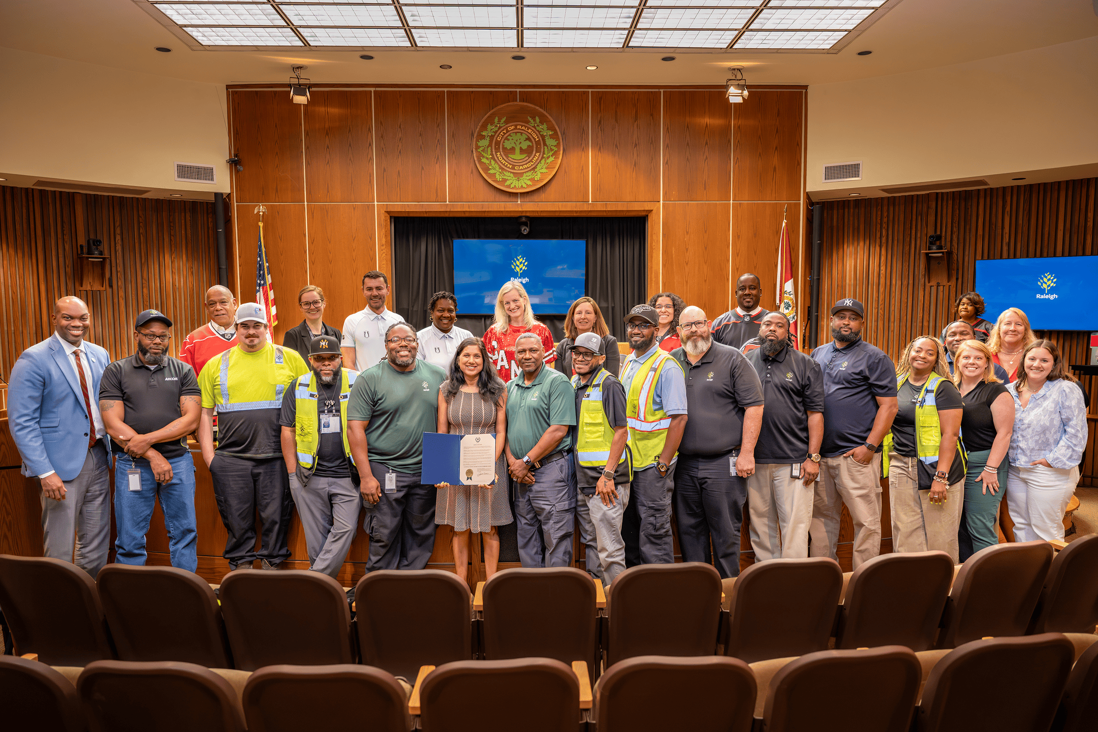 Solid Waste Services staff pose in the council chambers following the proclamation of Waste and Recycling Workers Week.