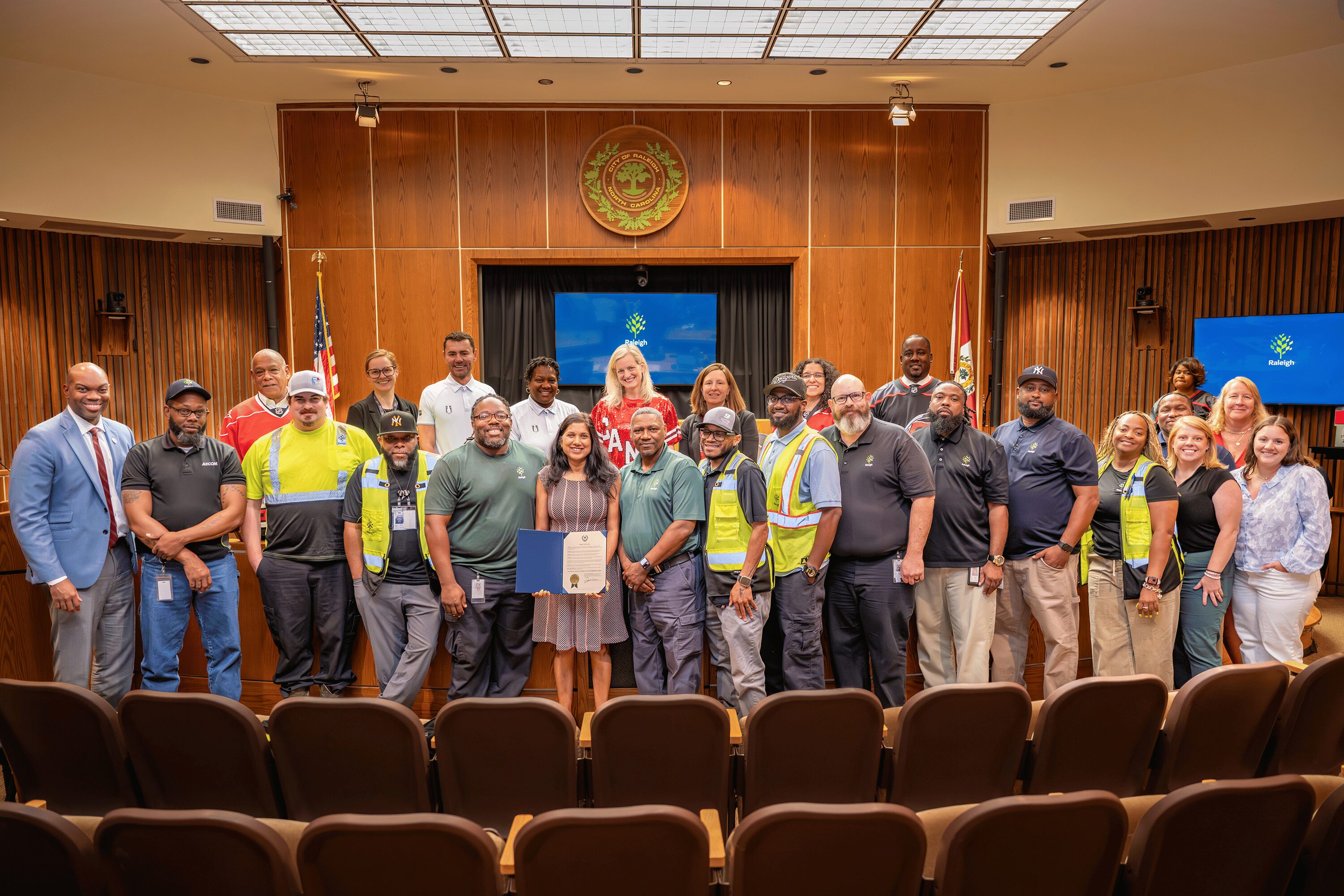 Solid Waste Services staff pose in the council chambers following the proclamation of Waste and Recycling Workers Week.