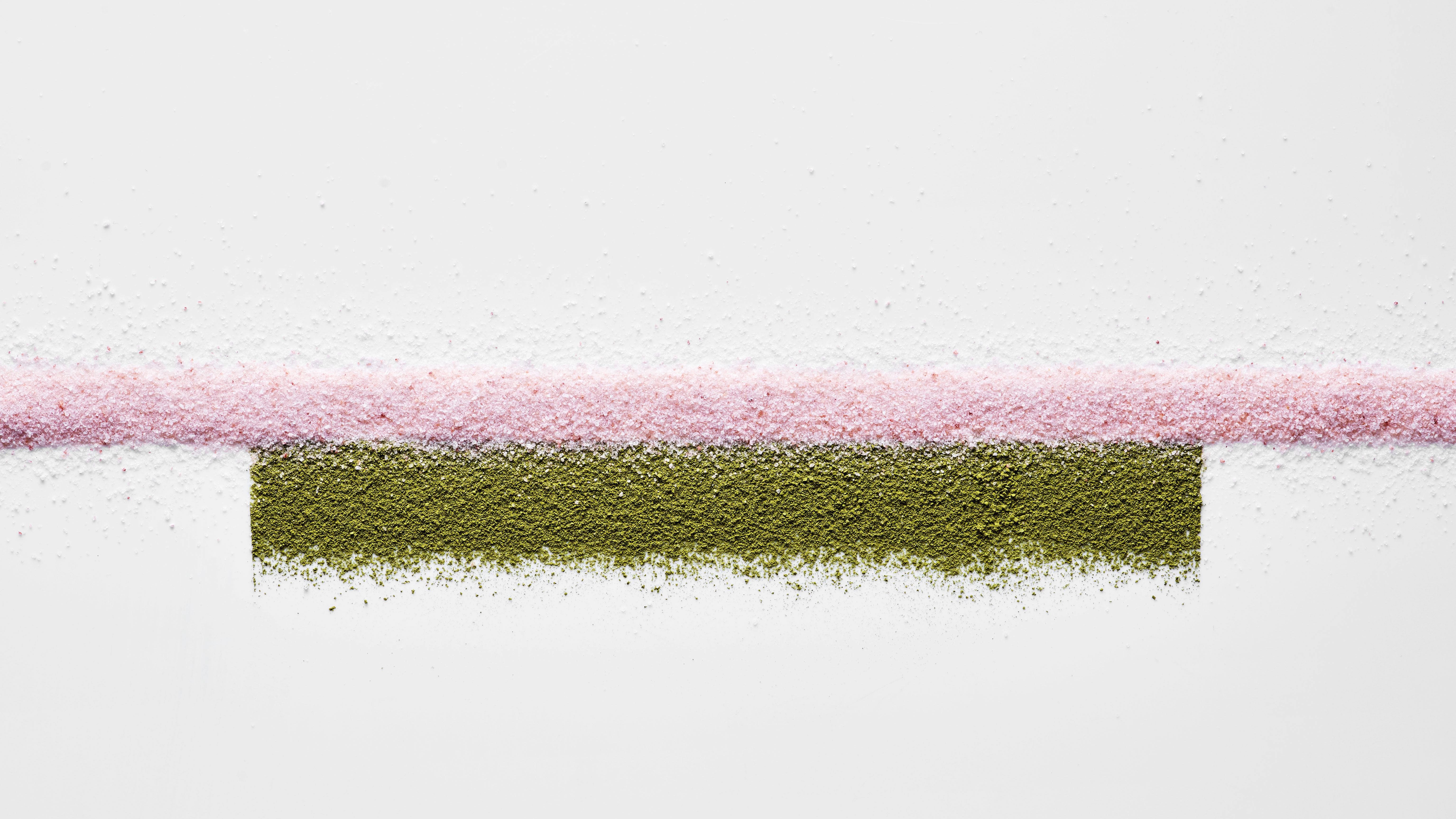 A horizontal pink powdered line stretches from side to side. A slightly thicker moss green powder rectangle is located just beneath the pink line. 