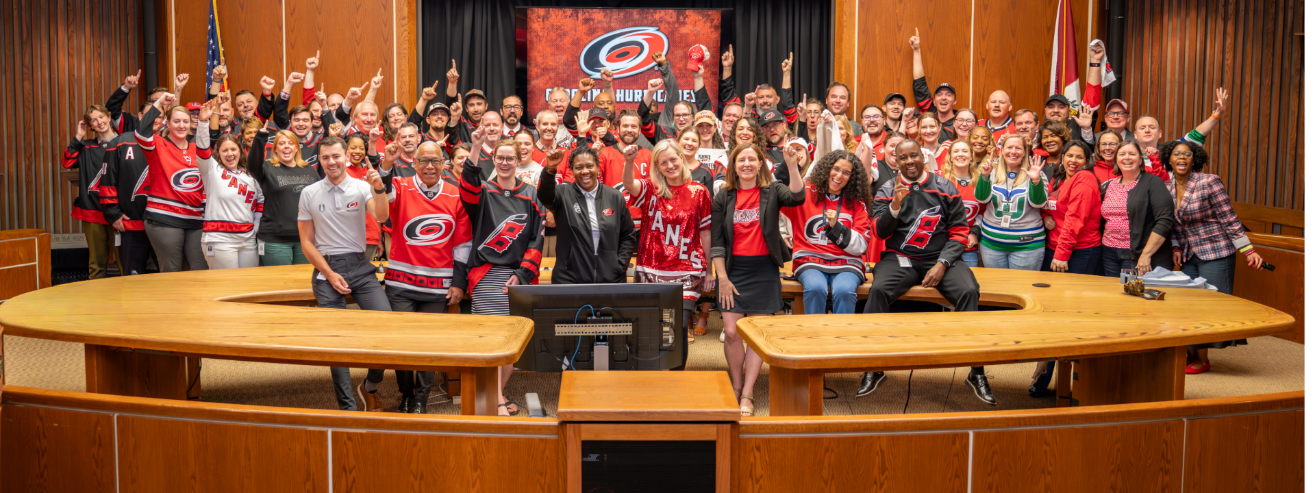 In Council chambers, COR staff and City Council dressed in Carolina Hurricanes gear
