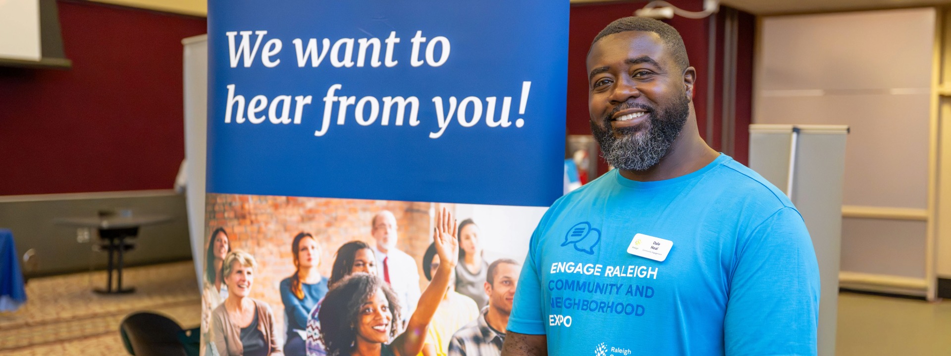 City of Raleigh employee and sign that states "We want to hear from you!"