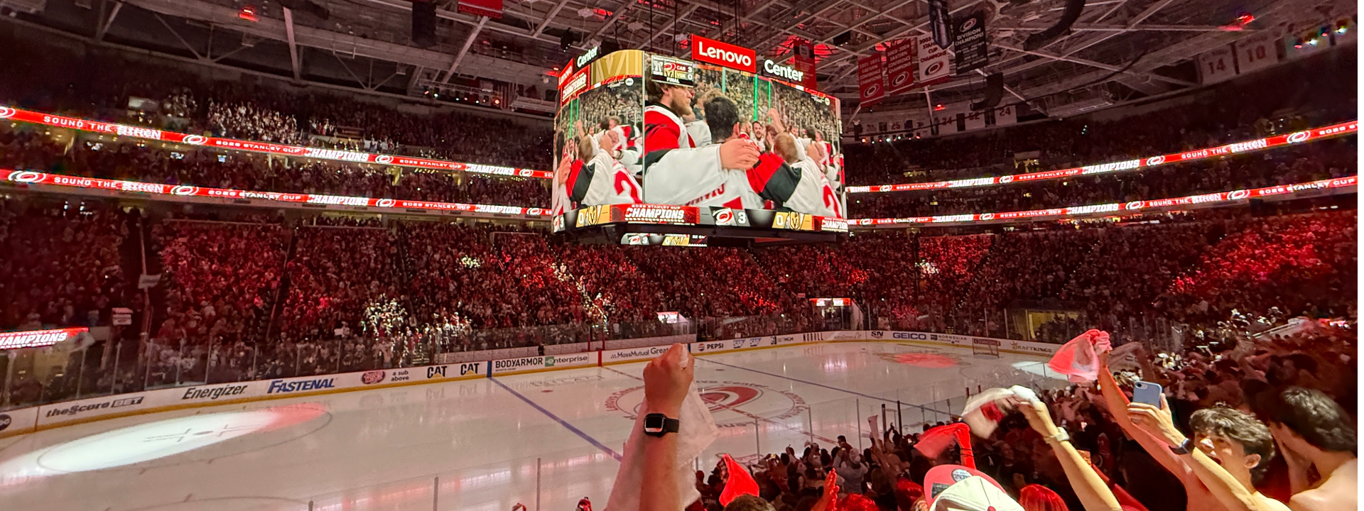Lenovo Center filled with cheering crowd and team celebrating on the jumbotron