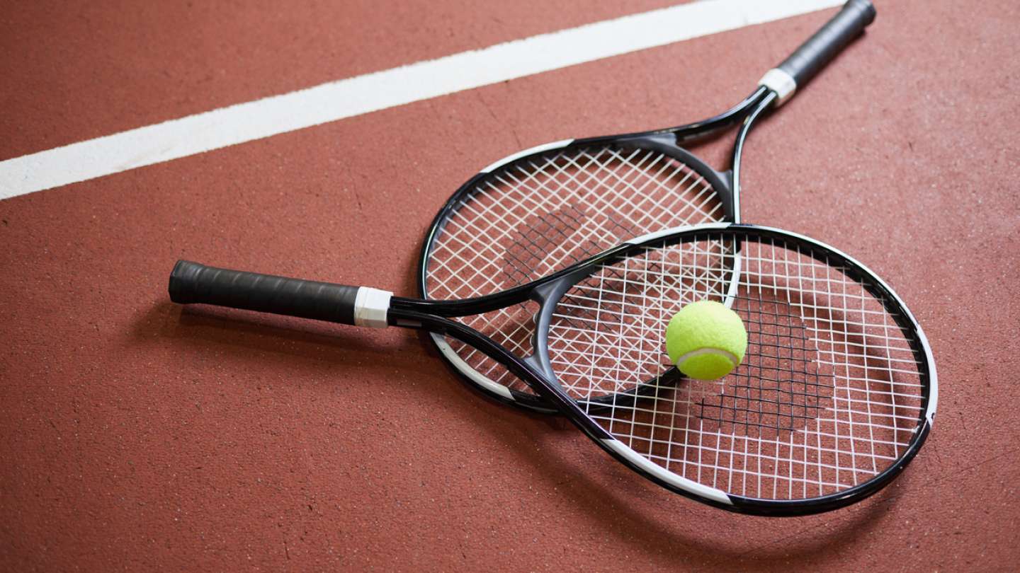 Two tennis racquets with a tennis ball