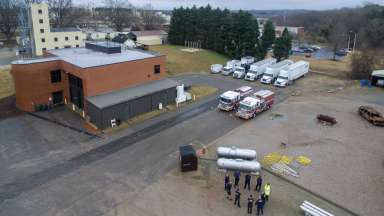 Aerial shot of firefighters standing in circle