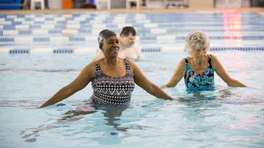 Adaptive aquatics program participants swimming lesson in pool