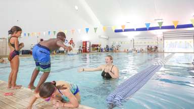 Children jumping into Millbrook Exchange pool for swimming programs