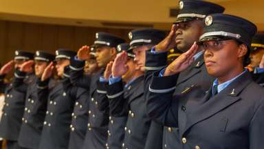 firefighters in dress uniform saluting