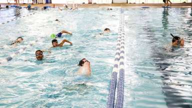 People swimming laps at Millbrook Exchange Pool.