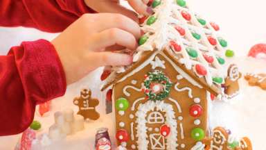 Children decorating a gingerbread house