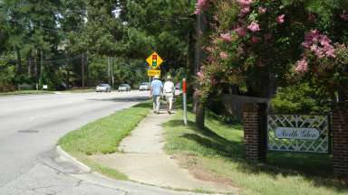 People walking on Six Forks Road 