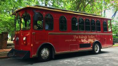 Historic Raleigh Trolley parked by trees