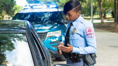 Female Raleigh police officer during a traffic stop talking to driver of vehicle