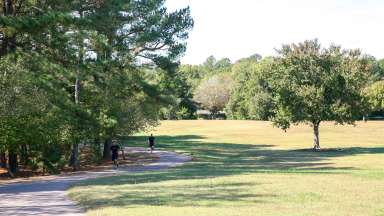 Men running on a trail at Spring Forest Park