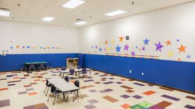 A second classroom with tables and chairs 