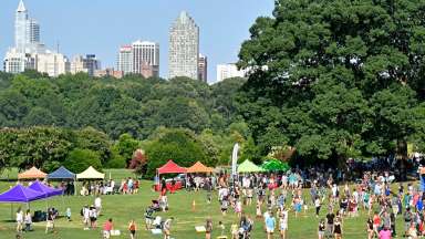 Tents and people on the lawn of Dix park during festival