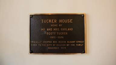 A plaque describing who lived in the Tucker House and where it used to be located
