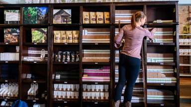Worker stocking shelves at videri chocolate