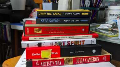 A stack of books in the studio of artist Lakeshia Reed