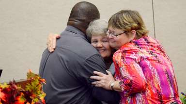 group hugging at mayor's persons with disabilities awards