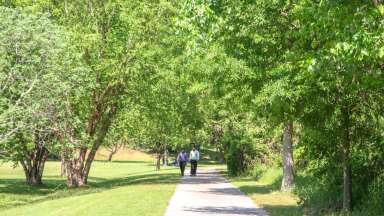 Two people walking on the greenway together