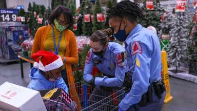 Police staff looks at child's purchases during event