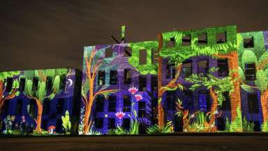 Artwork projected onto St. Agnes Hospital building by artists Omai