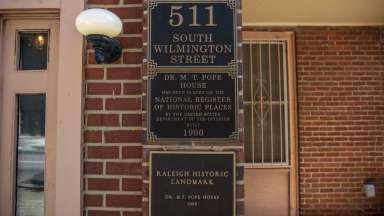 A shot of the landmark and address placards outside the Pope House 