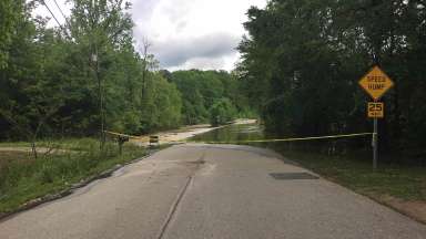 Rose Lane closed off with yellow tape because of flooding