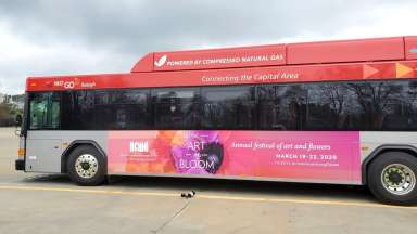 GoRaleigh bus with North Carolina Museum of Art "Art in Bloom" ad displayed on the side