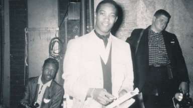 Sam Cooke flanked by two reporters backstage Memorial Auditorium, 1958