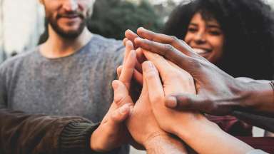 diverse hands in a huddle