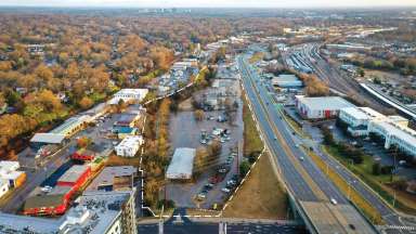 Birds eye view of land where future Devereux Meadows Park will be with white dotted line outlining boundary