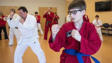 Instructor and students in karate class