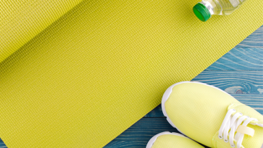 Tennis shoes with yoga mat and water bottle