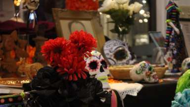Table with Day of the Dead mask and decorative items