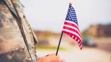 American military soldier with flag. Patriotic theme