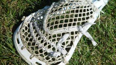 Lacrosse stick laying on the grass