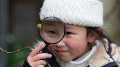 Girl with a magnifying glass searching for something
