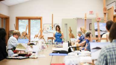 Group of adults taking a painting class at the local community center.