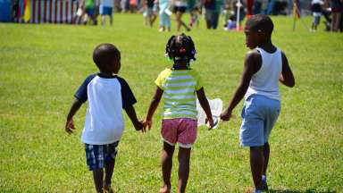 Children hold hands in Raleigh park