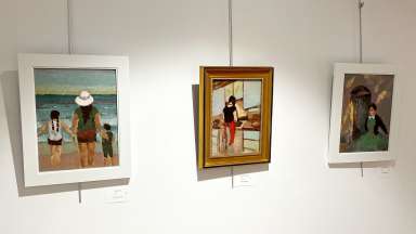 Paintings hang on the wall at Sertoma Arts Center