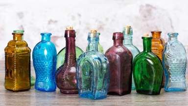 Photograph of several antique bottles of different colors.