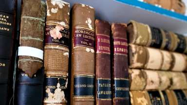 A close up of old law books on a book shelf.