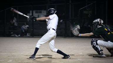 A boy swinging at a pitch.