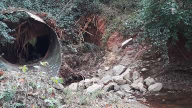 Shows culvert at Burgess Court and the current condition of streambed.