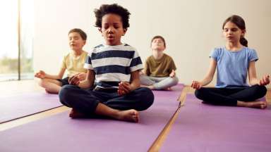 Children sitting quietly and meditating.